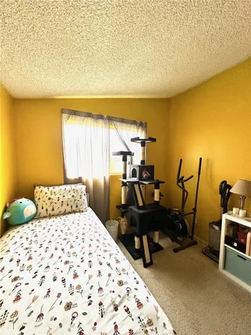 a bedroom with a bed and a desk