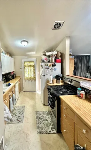 a kitchen with stove and cabinets