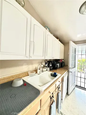 a kitchen with a sink a stove and cabinets