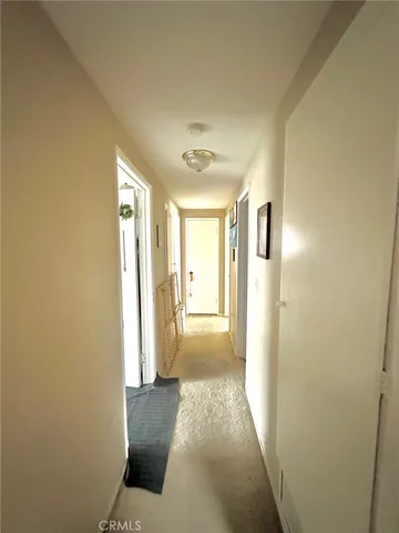 a view of hallway with a couch and wooden floor