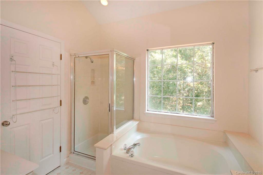 11931 Harris Ridge Drive Charlotte, NC 28269 - Photo 11 of 19 a bathroom with a bathtub and shower