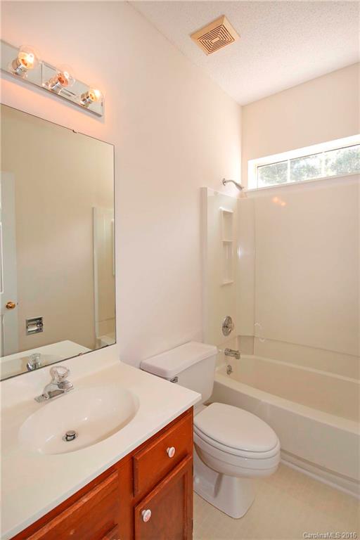11931 Harris Ridge Drive Charlotte, NC 28269 - Photo 14 of 19 a bathroom with a sink a toilet and shower