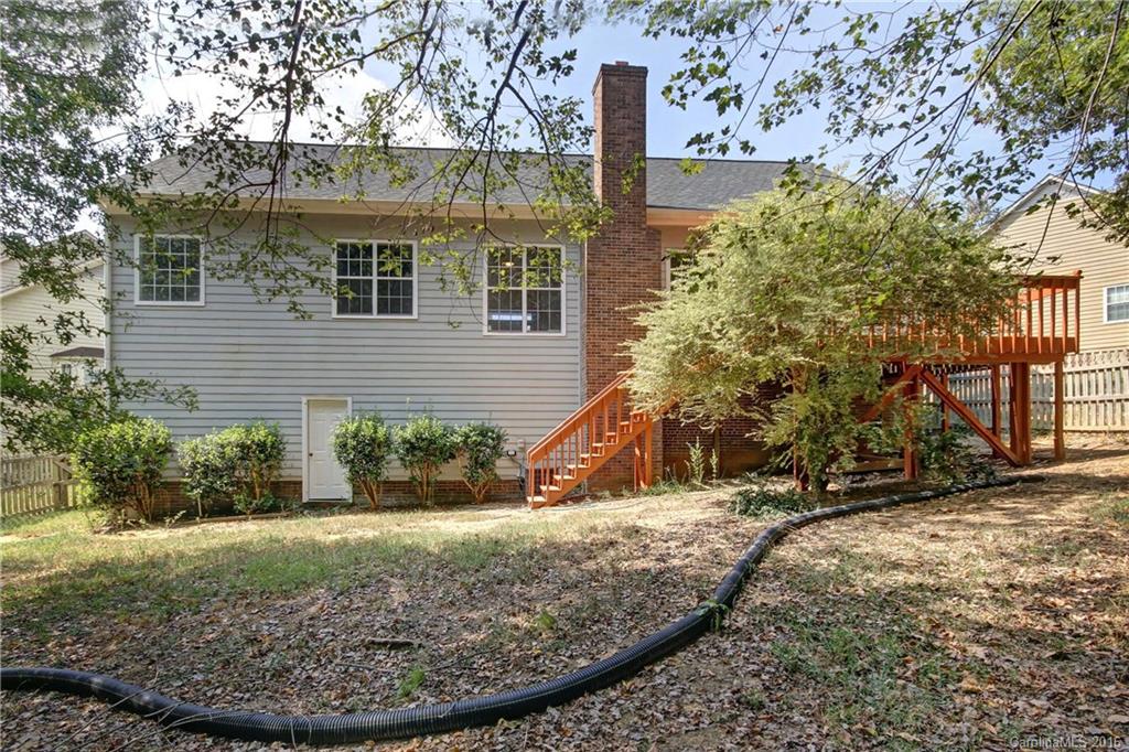11931 Harris Ridge Drive Charlotte, NC 28269 - Photo 18 of 19 a view of a house with a yard