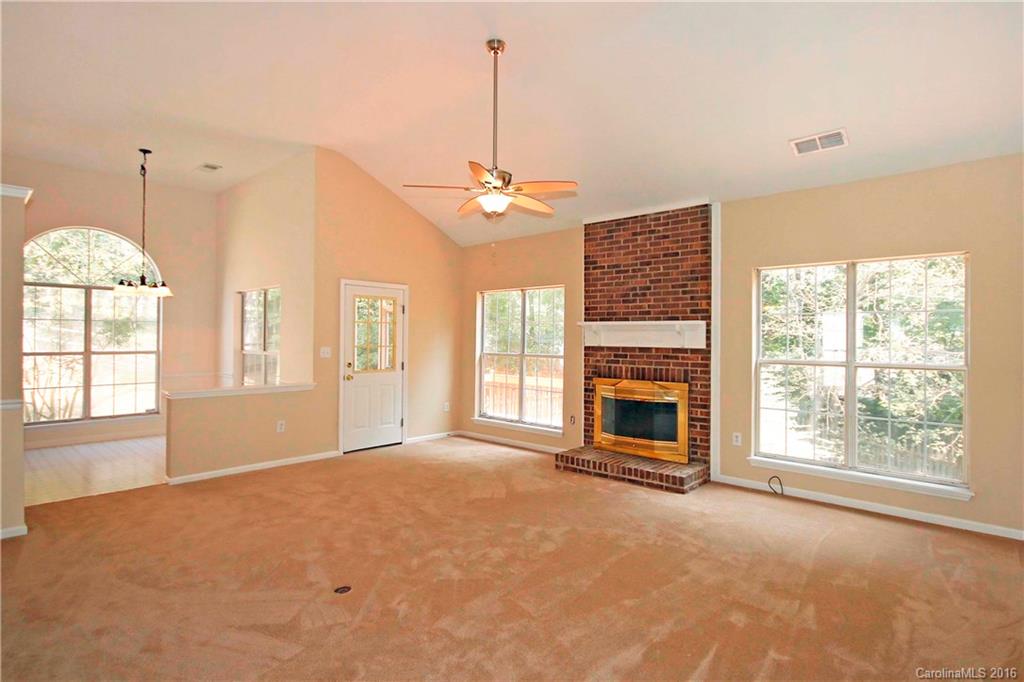 11931 Harris Ridge Drive Charlotte, NC 28269 - Photo 5 of 19 a view of an empty room with a fireplace and a window