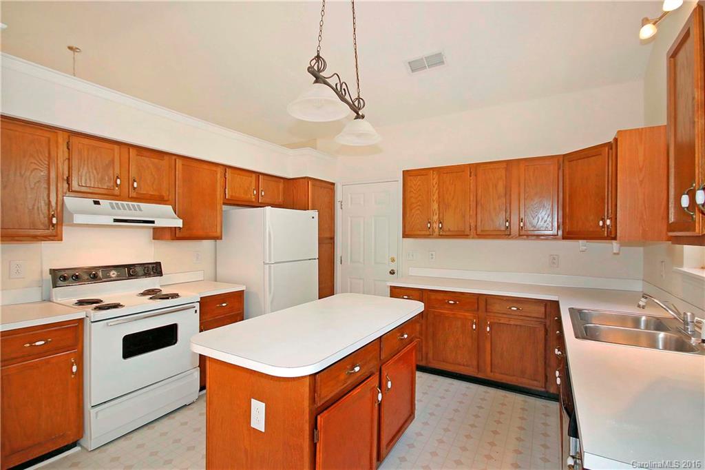 11931 Harris Ridge Drive Charlotte, NC 28269 - Photo 6 of 19 a kitchen with a stove sink and cabinets