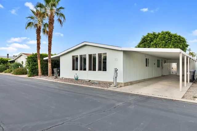 a front view of a house with yard and garage