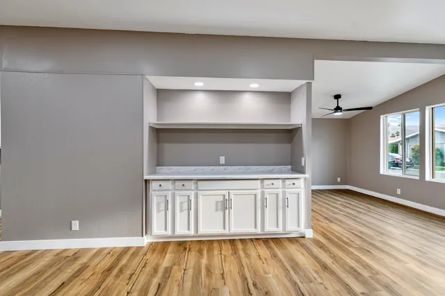 a view of a kitchen with wooden floor and a sink