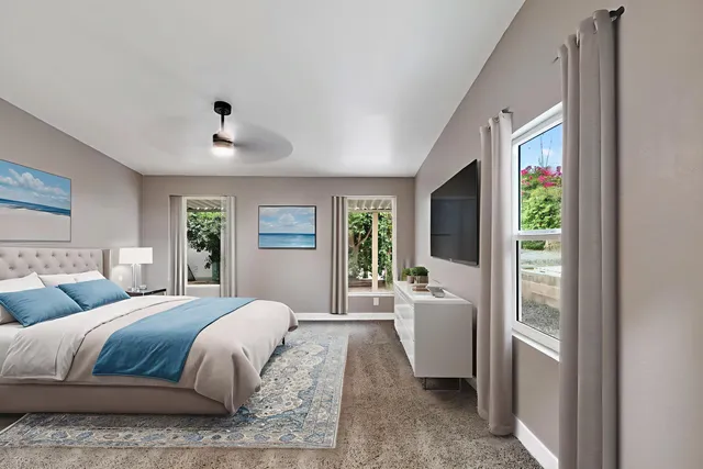 a bedroom with a large bed and a window