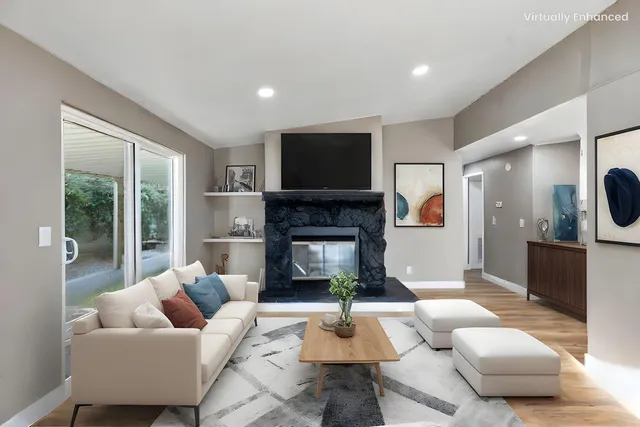 a living room with furniture and a fireplace