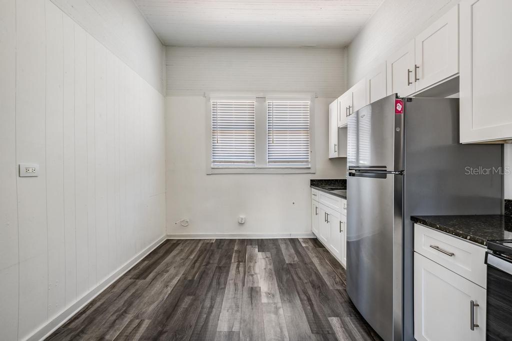 2319 West Aileen Street, Unit B Tampa, FL 33607 - Photo 12 of 19 a view of a kitchen with wooden floor and electronic appliances