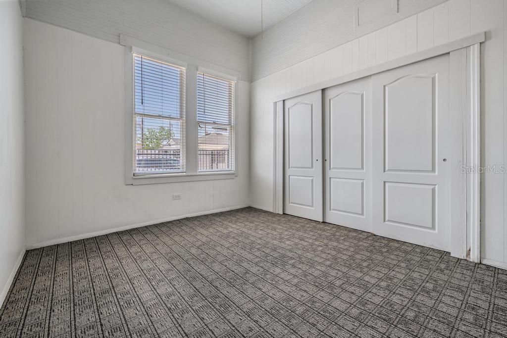 2319 West Aileen Street, Unit B Tampa, FL 33607 - Photo 16 of 19 a view of an empty room with wooden floor and a window