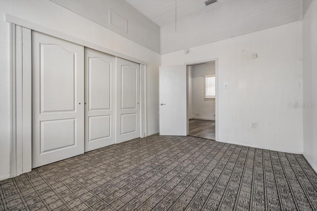2319 West Aileen Street, Unit B Tampa, FL 33607 - Photo 17 of 19 a view of an empty room with closet and wooden door