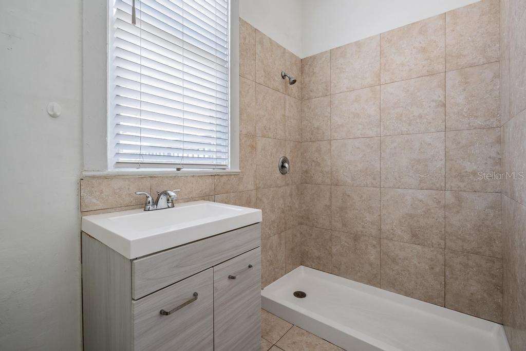 2319 West Aileen Street, Unit B Tampa, FL 33607 - Photo 18 of 19 a bathroom with a sink a toilet and shower