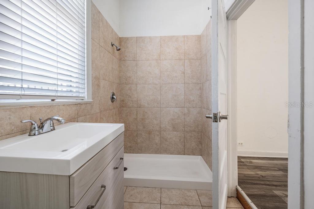2319 West Aileen Street, Unit B Tampa, FL 33607 - Photo 19 of 19 a bathroom with a sink a toilet and shower