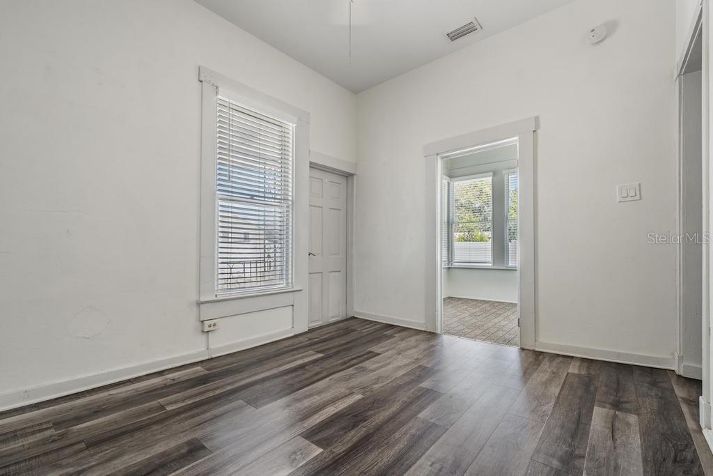 2319 West Aileen Street, Unit B Tampa, FL 33607 - Photo 8 of 19 a view of an empty room with wooden floor and a window