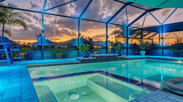 a view of a swimming pool with a patio and a yard