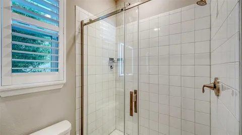 a bathroom with a shower and toilet
