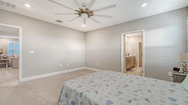 a bedroom with a bed and a view of kitchen