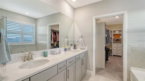 a en suite bathroom with double sink and a mirror