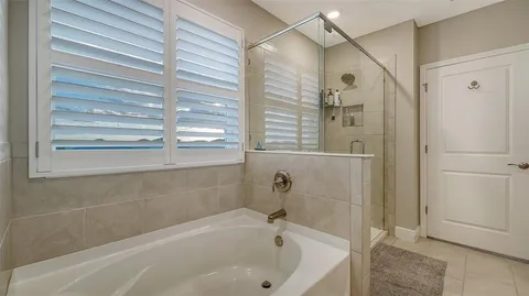 a bathroom with a bathtub and a shower