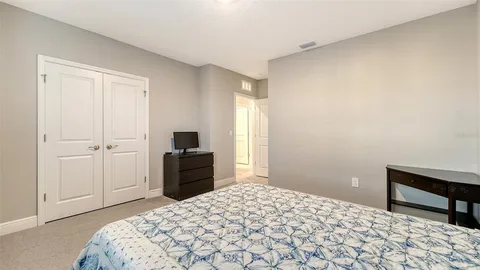 a bedroom with a bed and a dresser