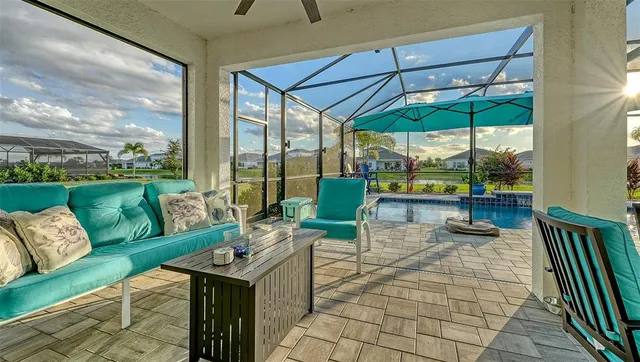 a view of a patio with couches and table under an umbrella