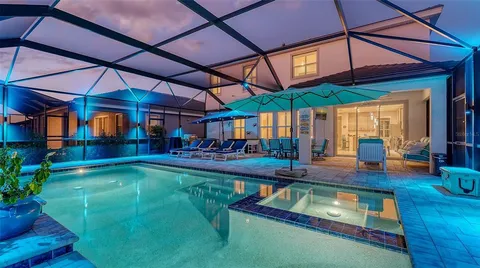 a view of a backyard patio with swimming pool table and chairs