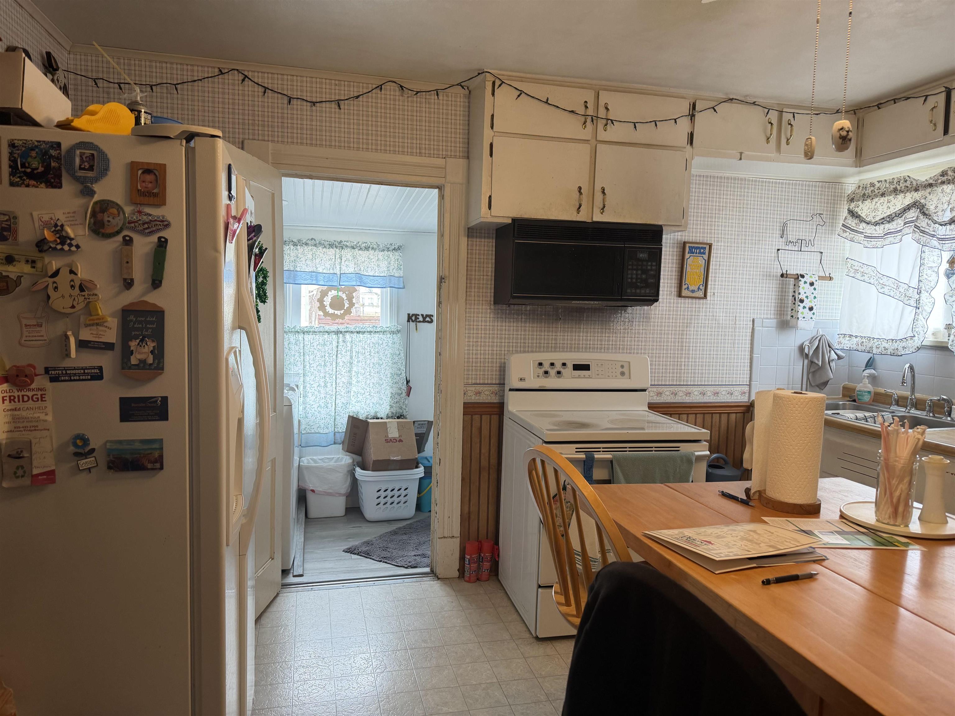 509 North Walnut Street Byron, IL 61010 - Photo 14 of 15 a open kitchen with a refrigerator and a stove top oven