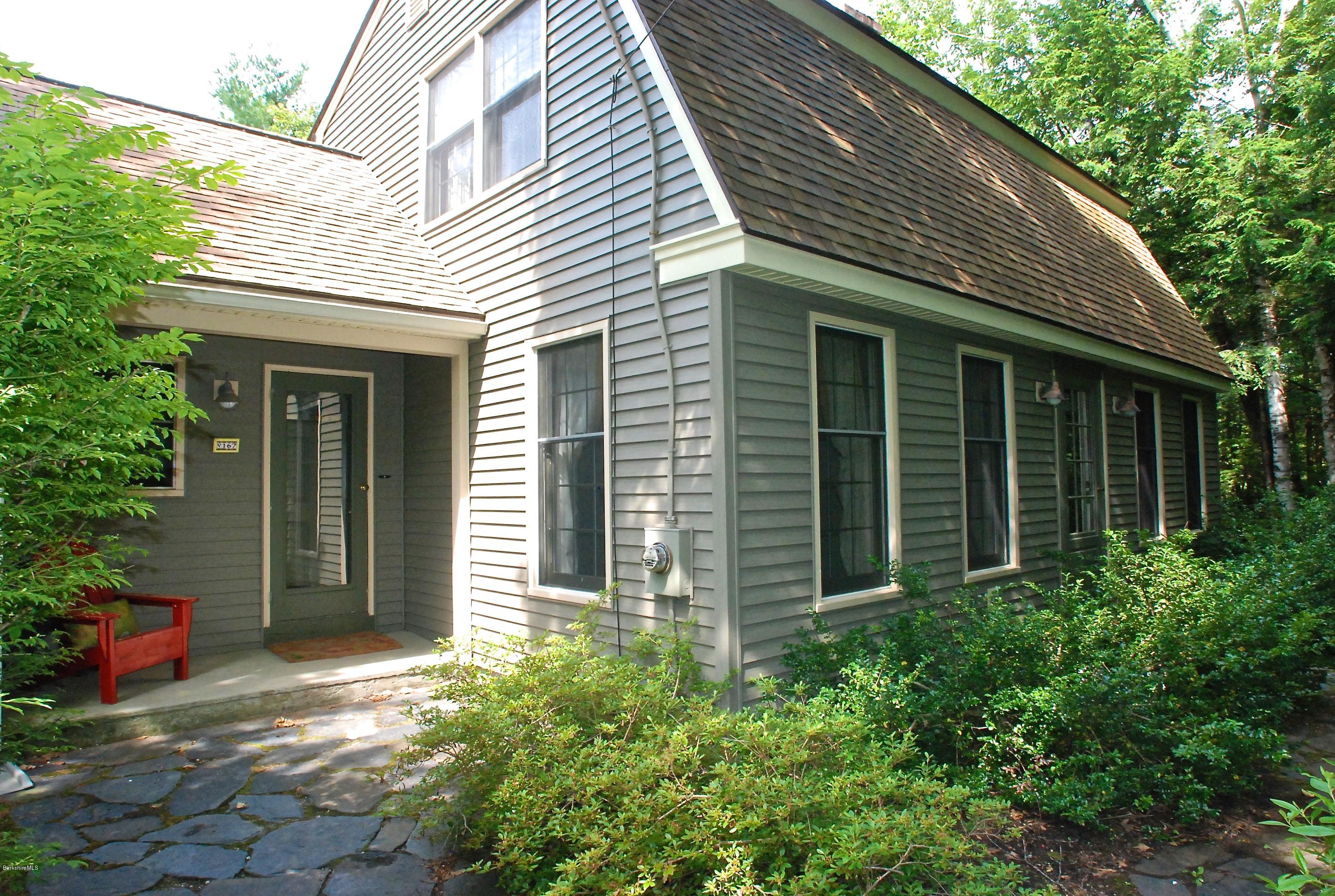 167 Tyringham Road Otis, MA 01253 - Photo 22 of 22 a view of a house with potted plants and a table and chair