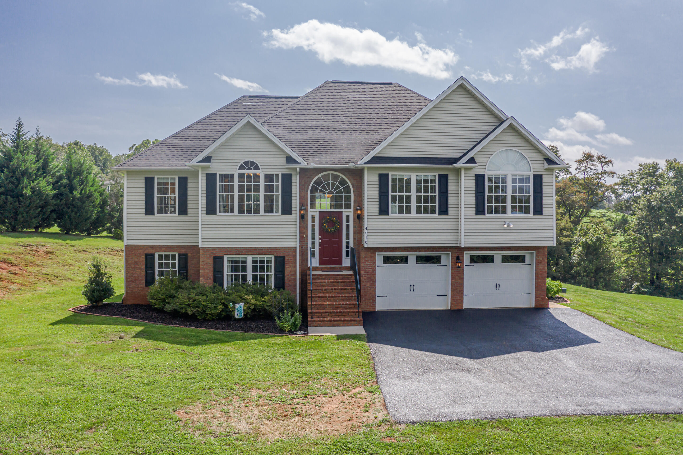 4510 Bethlehem Road Boones Mill, VA 24065 - Photo 1 of 48 a front view of a house with a yard and garage