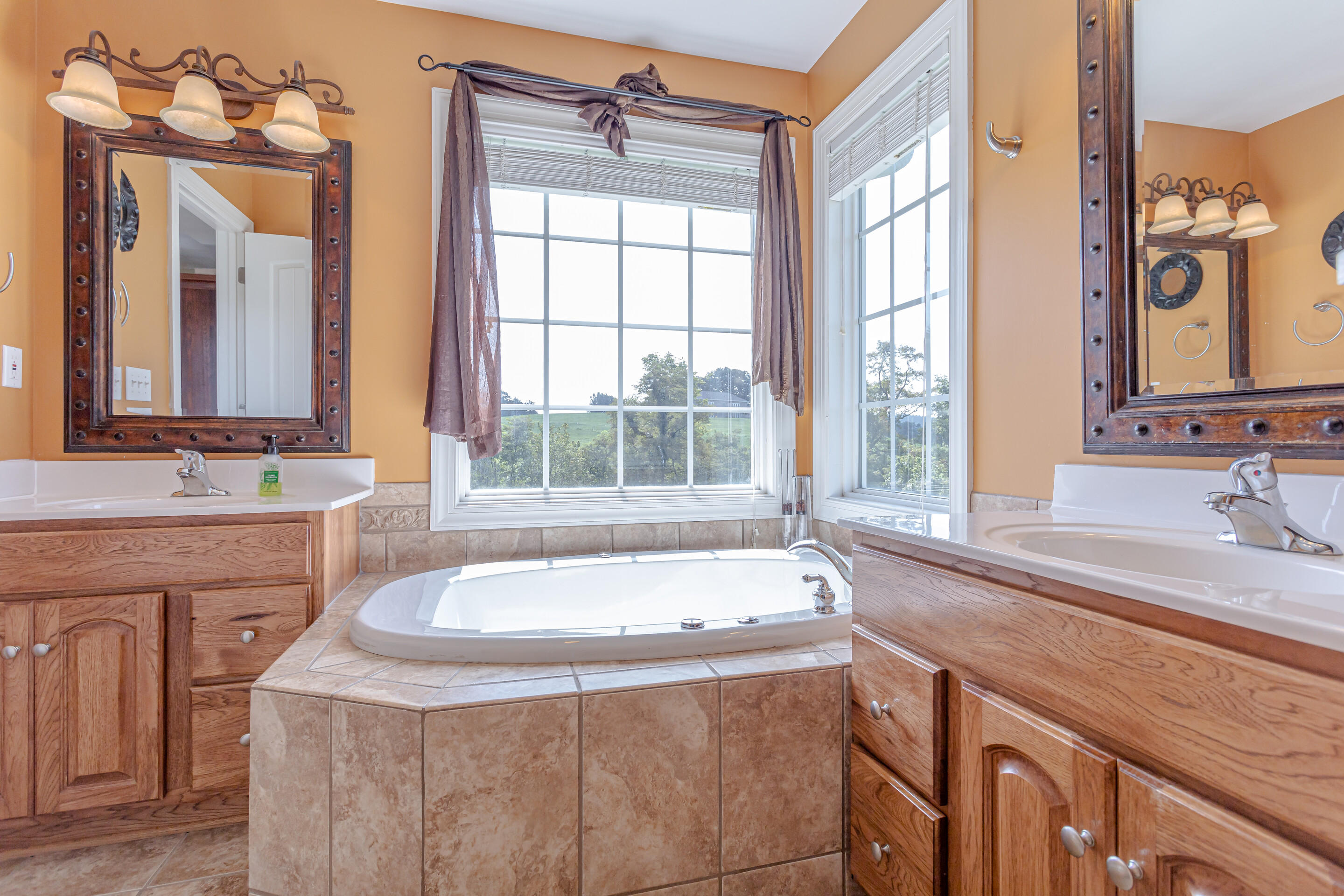 4510 Bethlehem Road Boones Mill, VA 24065 - Photo 16 of 48 a bathroom with a granite countertop sink and a bathtub