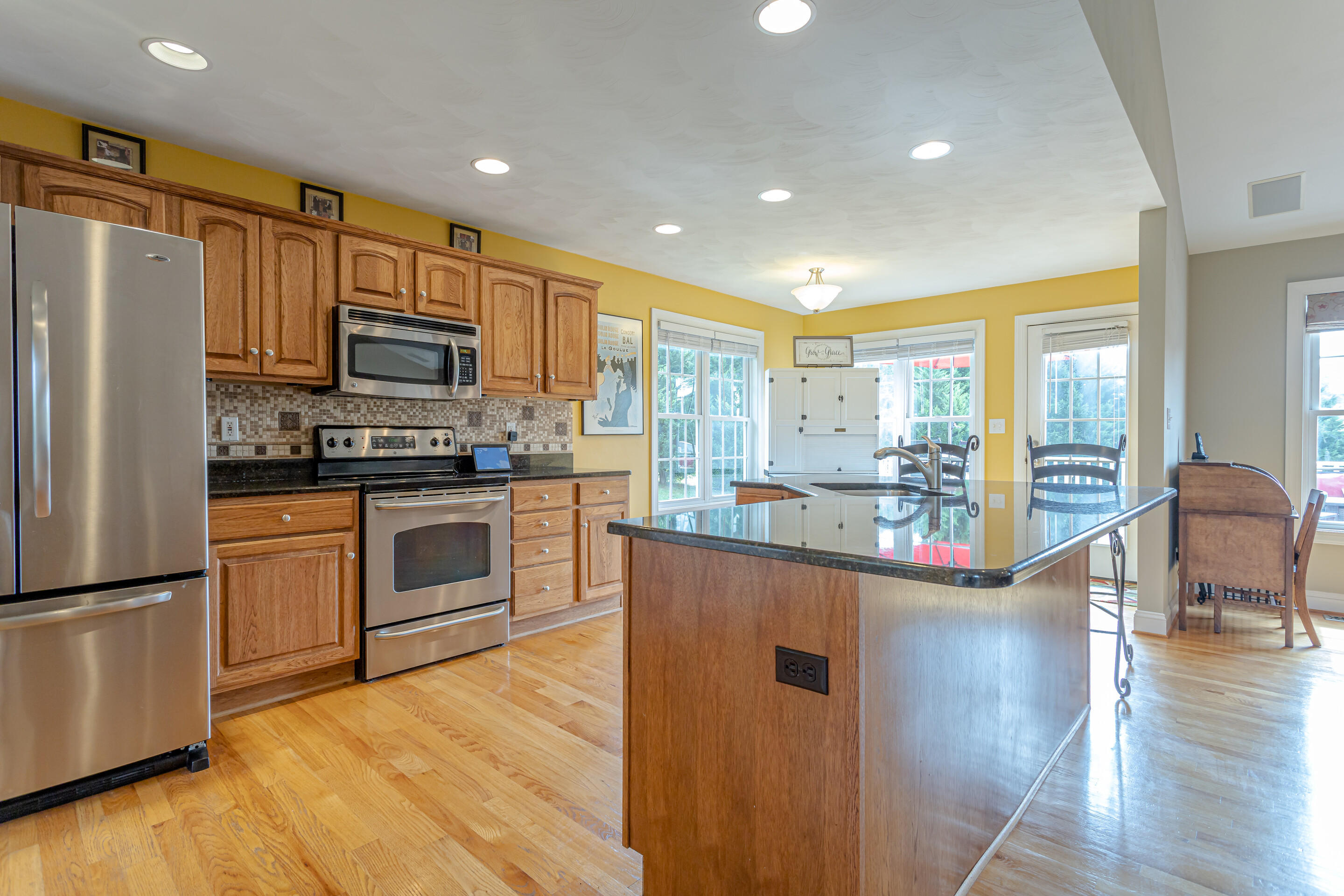 4510 Bethlehem Road Boones Mill, VA 24065 - Photo 9 of 48 a kitchen with stainless steel appliances a refrigerator a stove top oven and a sink