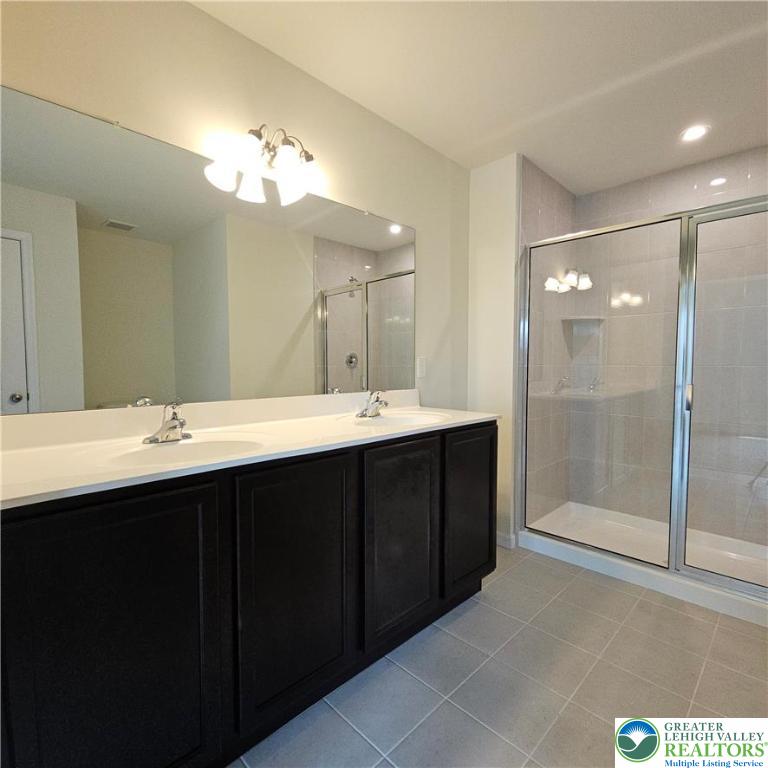 629 Fountain View Circle, Unit 8 Allentown, PA 18104 - Photo 11 of 16 a bathroom with a sink vanity and a mirror