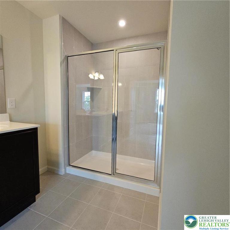 629 Fountain View Circle, Unit 8 Allentown, PA 18104 - Photo 12 of 16 a bathroom with a glass shower door