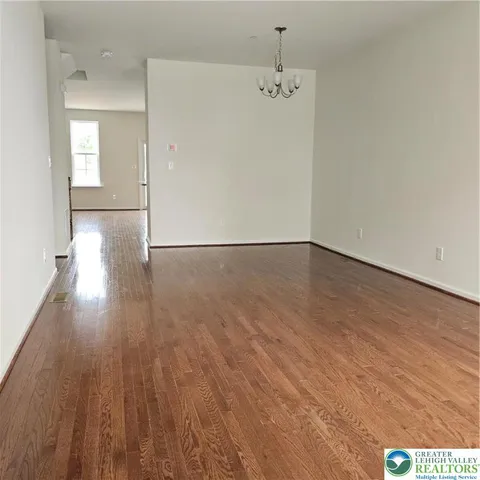 a view of a room with wooden floor