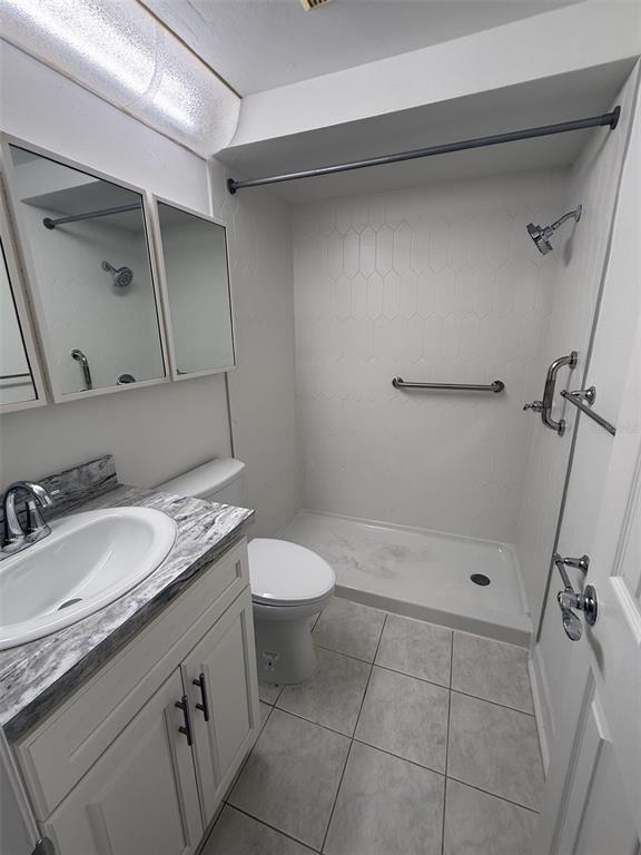 4413 Sunstate Drive New Port Richey, FL 34652 - Photo 11 of 14 a bathroom with a granite countertop sink a mirror and a toilet