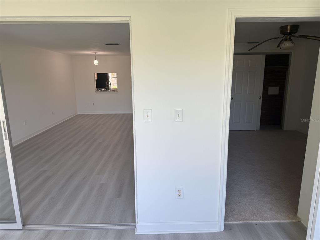 4413 Sunstate Drive New Port Richey, FL 34652 - Photo 12 of 14 a view of a hallway with wooden floor