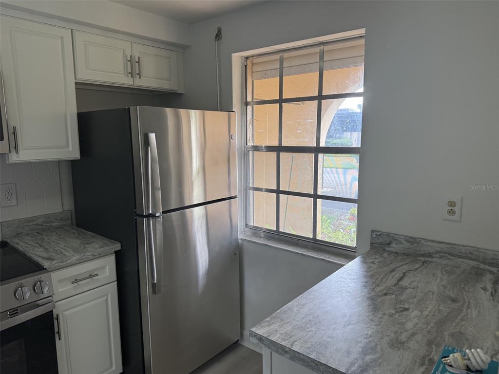 4413 Sunstate Drive New Port Richey, FL 34652 - Photo 4 of 14 a metallic refrigerator freezer sitting in a kitchen