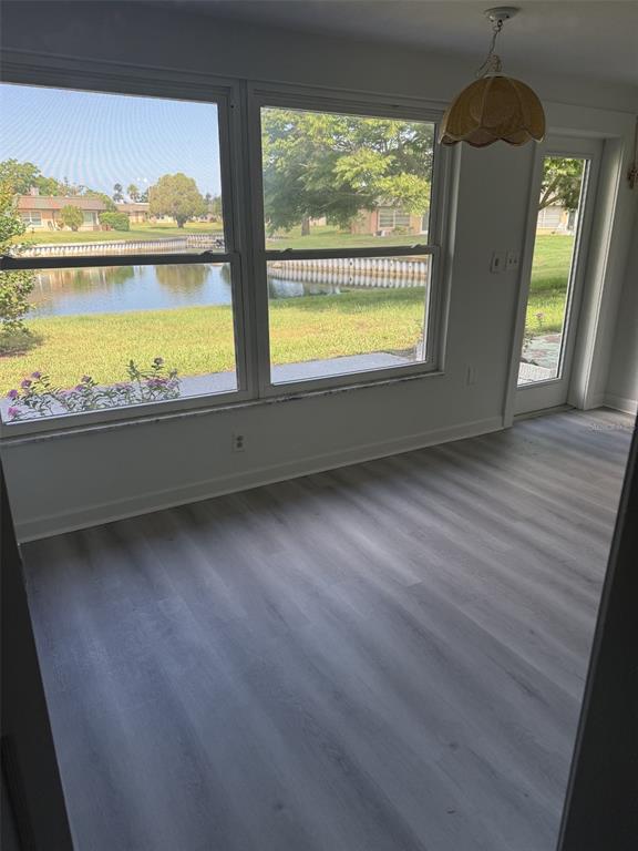 4413 Sunstate Drive New Port Richey, FL 34652 - Photo 8 of 14 a view of an empty room with a window and wooden floor