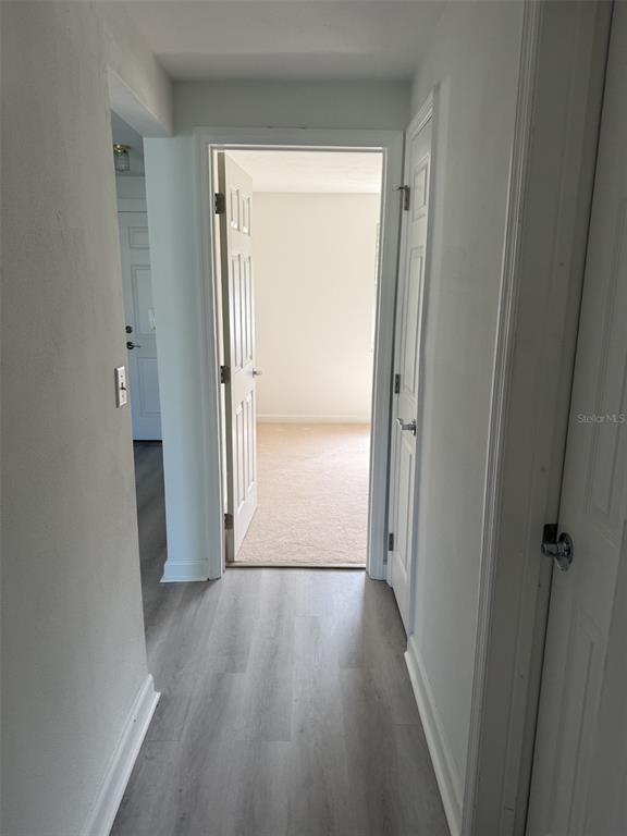 4413 Sunstate Drive New Port Richey, FL 34652 - Photo 9 of 14 a view of a hallway with wooden floor
