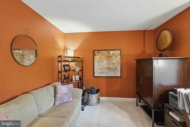 a living room with a couch and a mirror