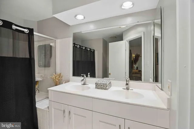 a bathroom with a double vanity sink mirror and double