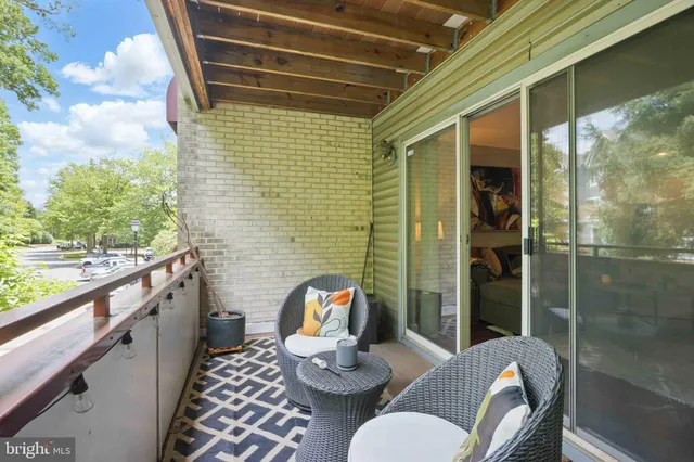 a balcony with table and chairs