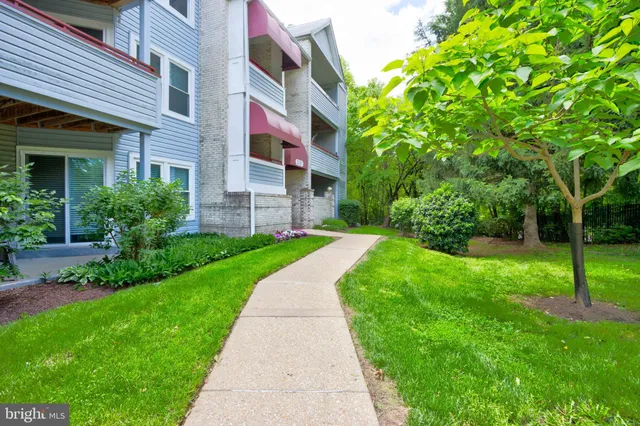 a view of a brick building next to a yard