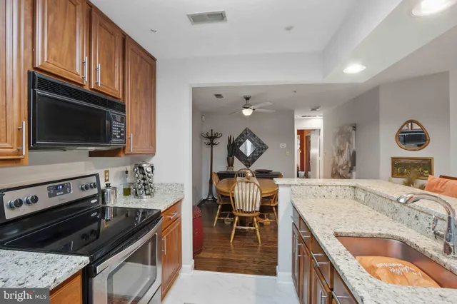 a kitchen with sink stove and cabinets