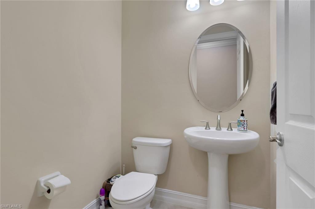 16309 Aberdeen Way Naples, FL 34110 - Photo 18 of 34 a bathroom with a sink mirror and toilet