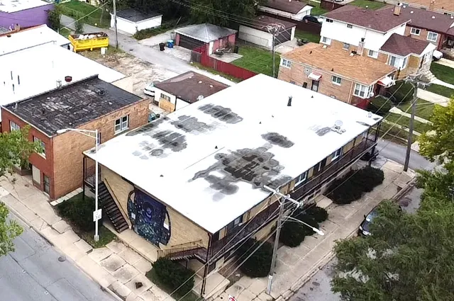 an aerial view of a house with a yard