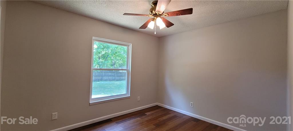 707 Finley Road Rock Hill, SC 29730 - Photo 12 of 26 an empty room with wooden floor fan and windows