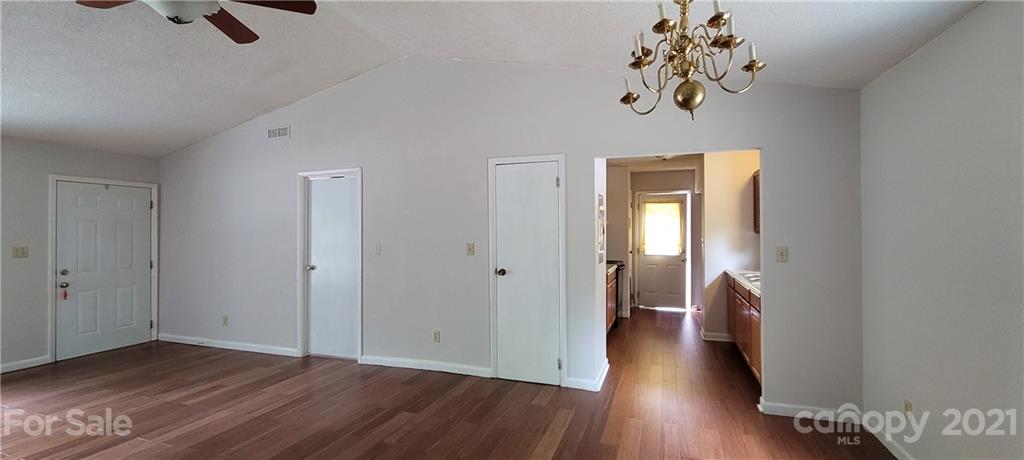 707 Finley Road Rock Hill, SC 29730 - Photo 6 of 26 a view of a hallway with wooden floor and chandelier