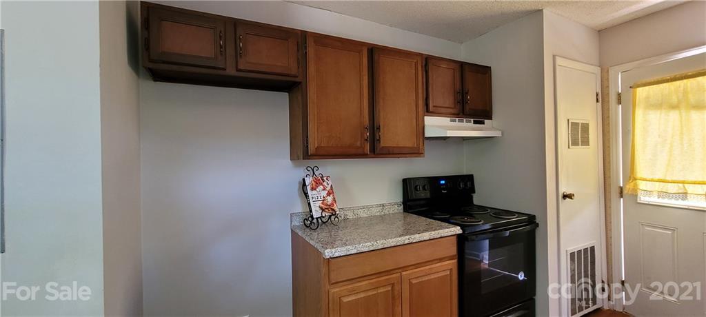 707 Finley Road Rock Hill, SC 29730 - Photo 7 of 26 a kitchen with stainless steel appliances granite countertop a stove top oven microwave and cabinets
